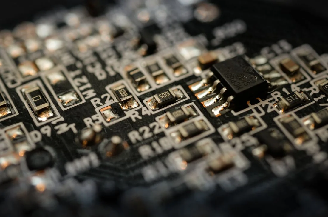 Close-up photograph of a microchip and components on an electronic circuit board